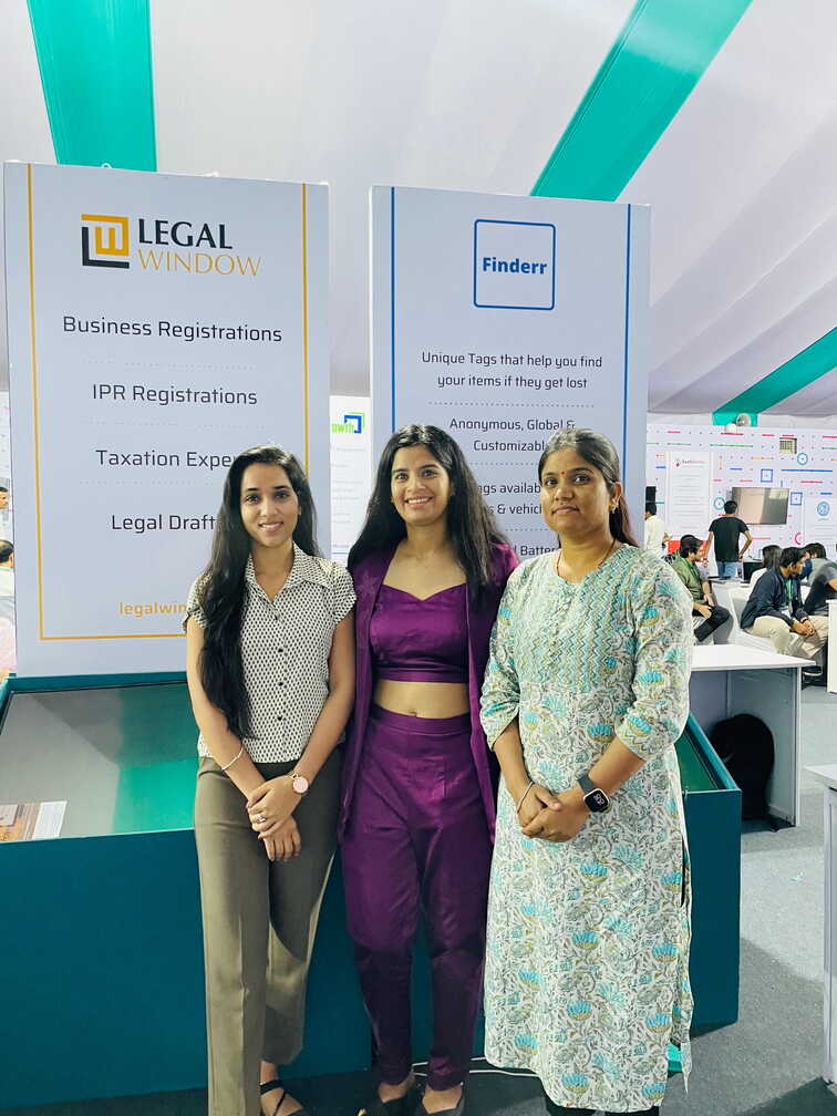 Three members of the Legal Window team at the company stall at an event