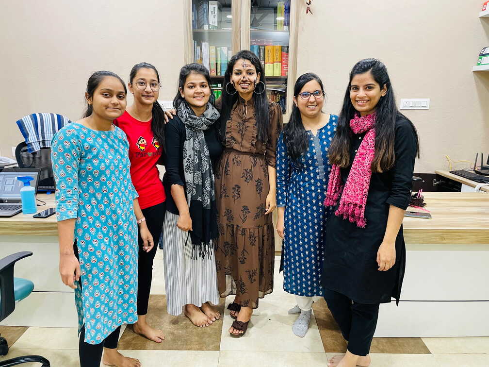 Team members together beside the office bookshelves