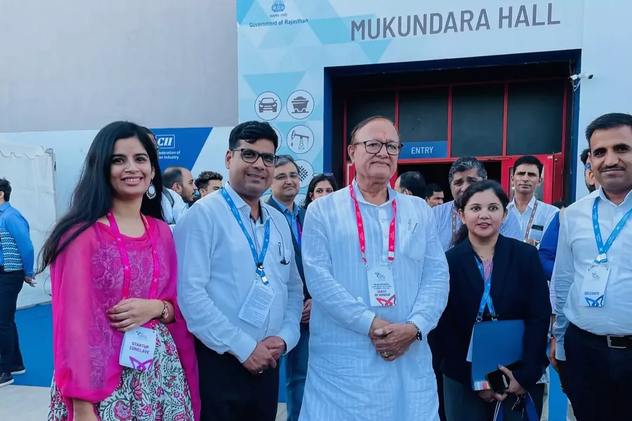 The team with officials outside Mukundara Hall at a CII event