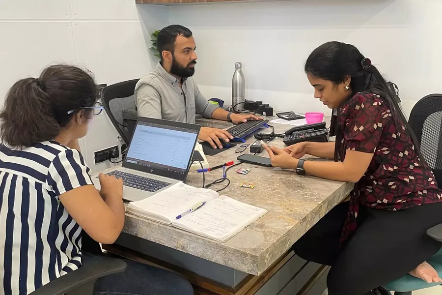 Three members of the team going through paperwork together at a desk