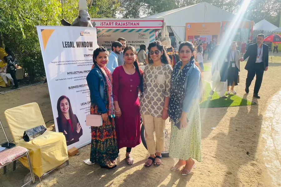 Legal Window's stall at an iSTART Rajasthan event, with the team standing beside the banner